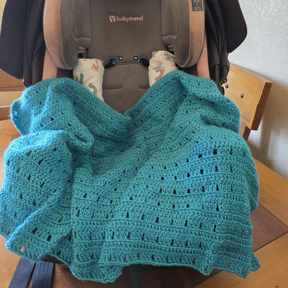 Handmade teal crochet baby blanket—perfect for the car seat or stroller.